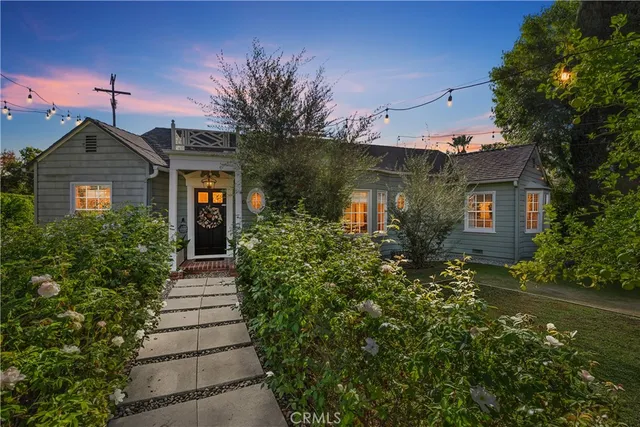 a front view of a house with plants