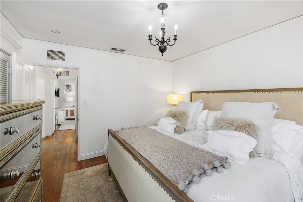 5306 Norwich Avenue Sherman Oaks, CA 91411 - Photo 18 of 43 a bedroom with a bed and a chandelier