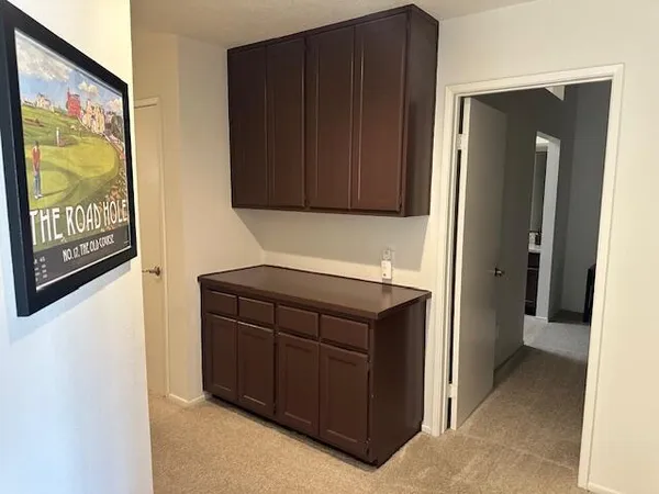 a kitchen with a refrigerator and a cabinets
