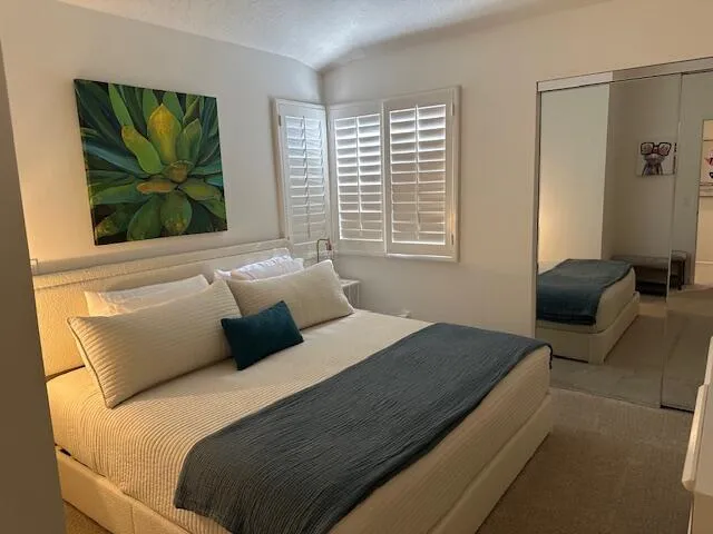 a bedroom with a bed and a flat tv screen