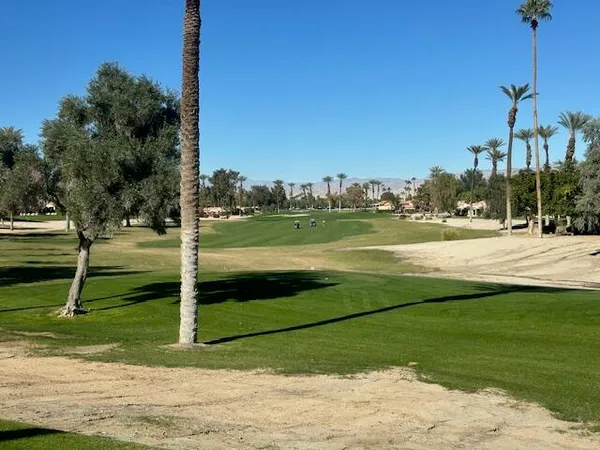 a view of a golf course with a lake view