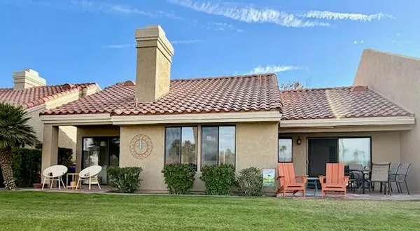 a front view of a house with garden