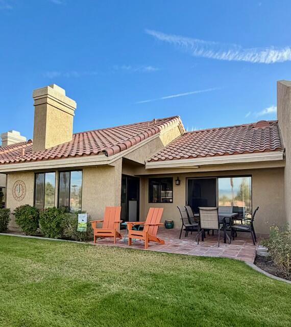 41869 Preston Trail Palm Desert, CA 92211 - Photo 21 of 23 a view of a patio with table and chairs potted plants and large tree