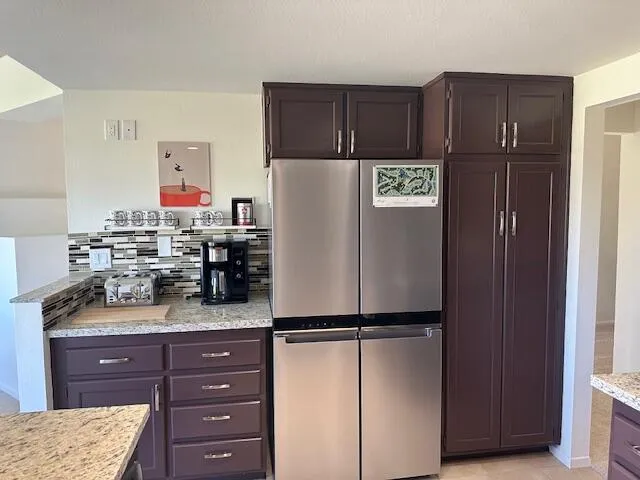 a kitchen with refrigerator and window