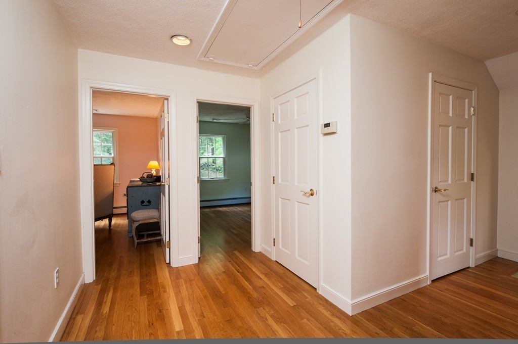 5 Holmes Road Boxford, MA 01921 - Photo 16 of 30 a view of a hallway with wooden floor and furniture