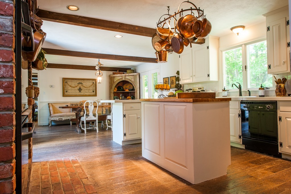 5 Holmes Road Boxford, MA 01921 - Photo 2 of 30 a kitchen with stainless steel appliances kitchen island granite countertop a stove top oven a sink a dining table and chairs with the floor