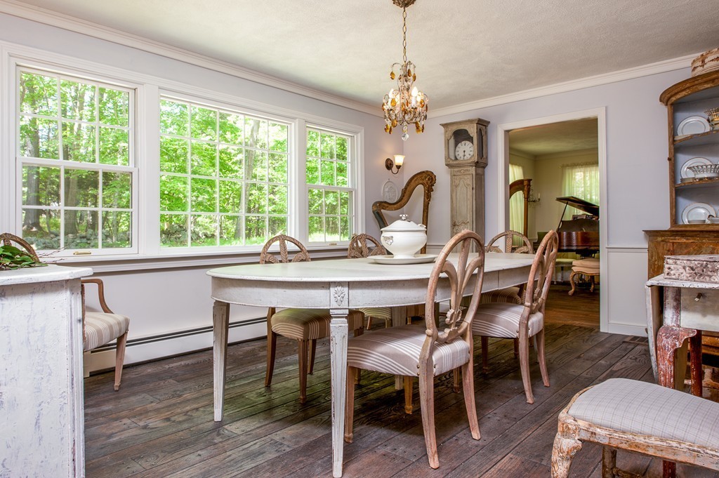 5 Holmes Road Boxford, MA 01921 - Photo 9 of 30 a dining room with wooden floor a chandelier a wooden table and chairs