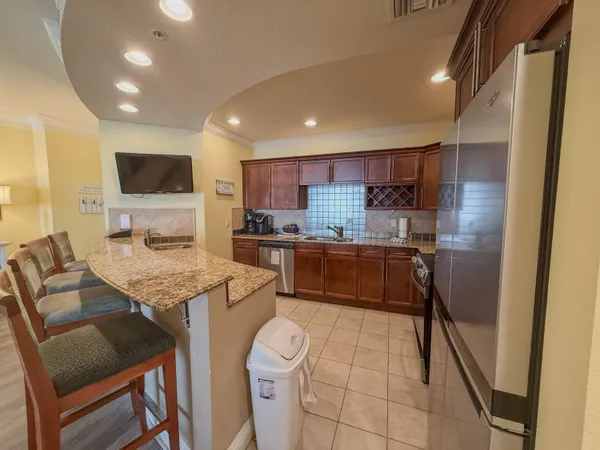a kitchen with a sink refrigerator and microwave