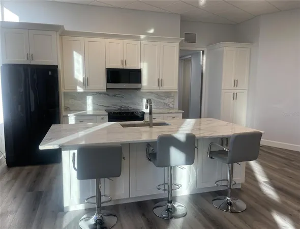 a bathroom with a granite countertop sink mirror and shower