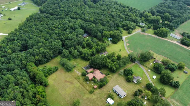 an aerial view of a house with a yard