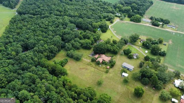 an aerial view of a house with a yard