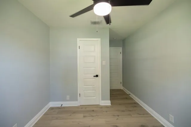 an empty room with wooden floor