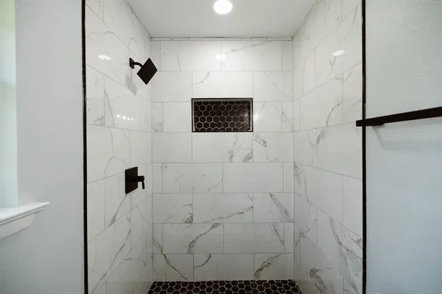a bathroom with a shower and a mirror