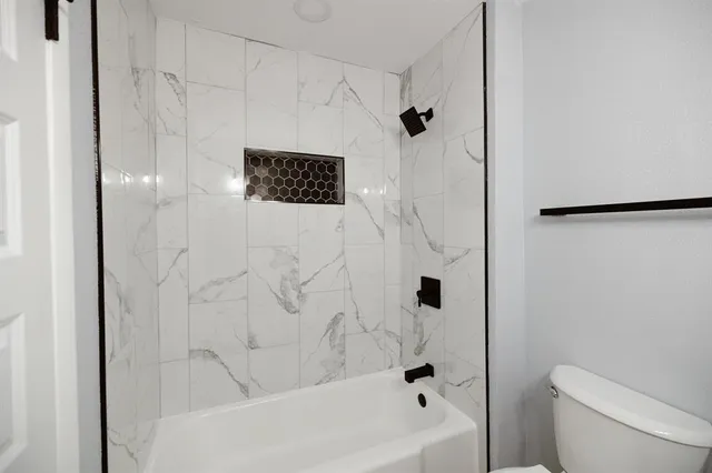 a bathroom with a shower and a toilet