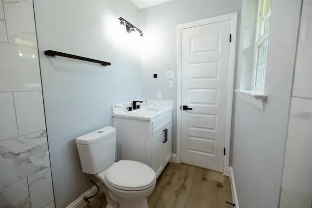 a white toilet sitting next to a bathroom sink
