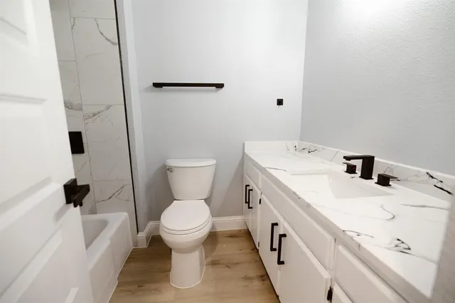 a bathroom with a sink a toilet and a bathtub