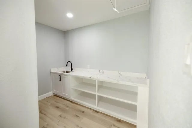 a room with a sink and a mirror