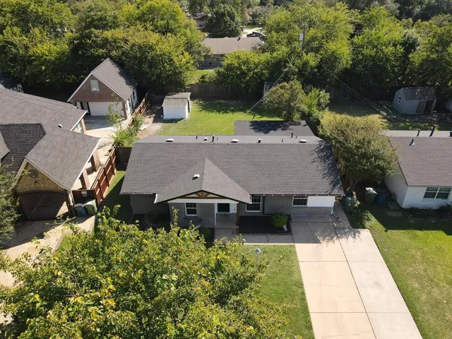 an aerial view of a house with a yard