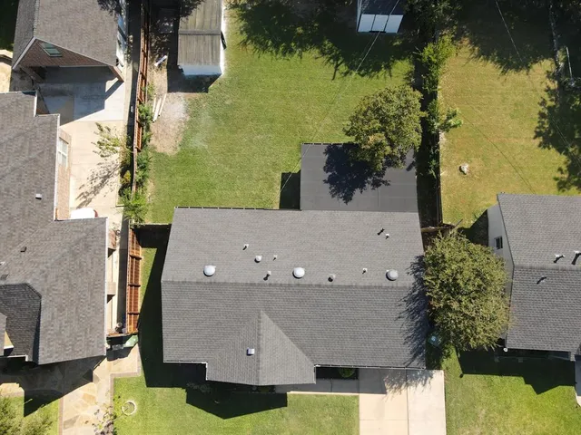 an aerial view of a house with a swimming pool