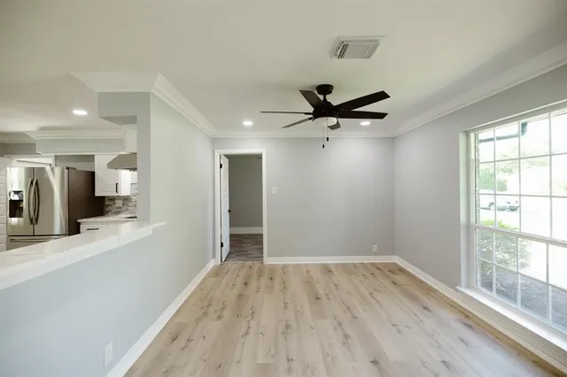 a view of a livingroom with a hardwood floor and a ceiling fan