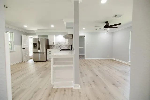 a view of a living room and a ceiling fan