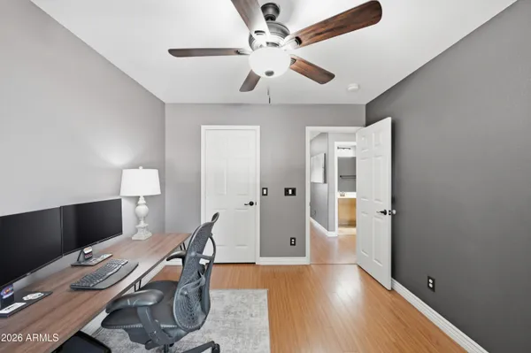 a view of a workspace with furniture and a window