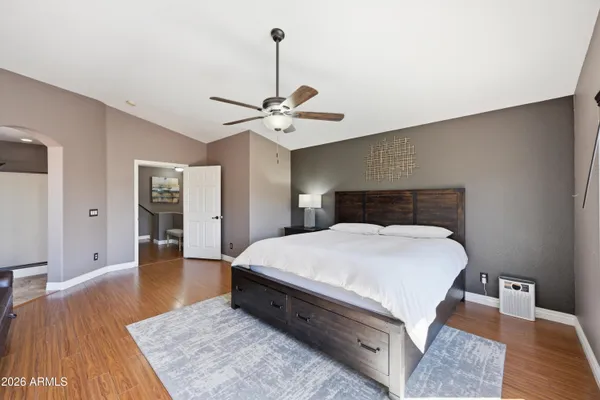 a bedroom with a bed and closet with wooden floor