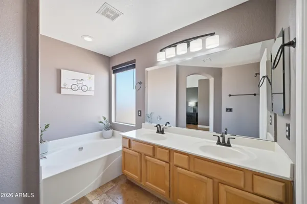 a bedroom with a large bed and a flat tv screen