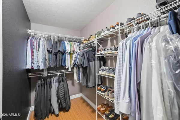 a bathroom with a tub shower sink and mirror