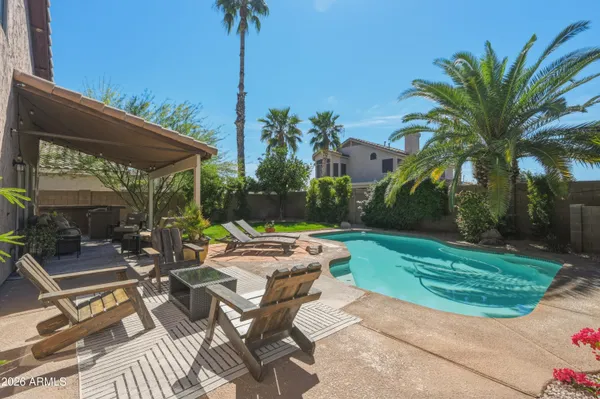 a view of a backyard with sitting area and furniture