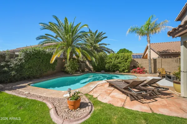 a view of a house with backyard and sitting area