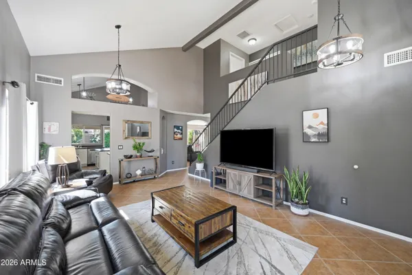 a living room with furniture potted plant and a window
