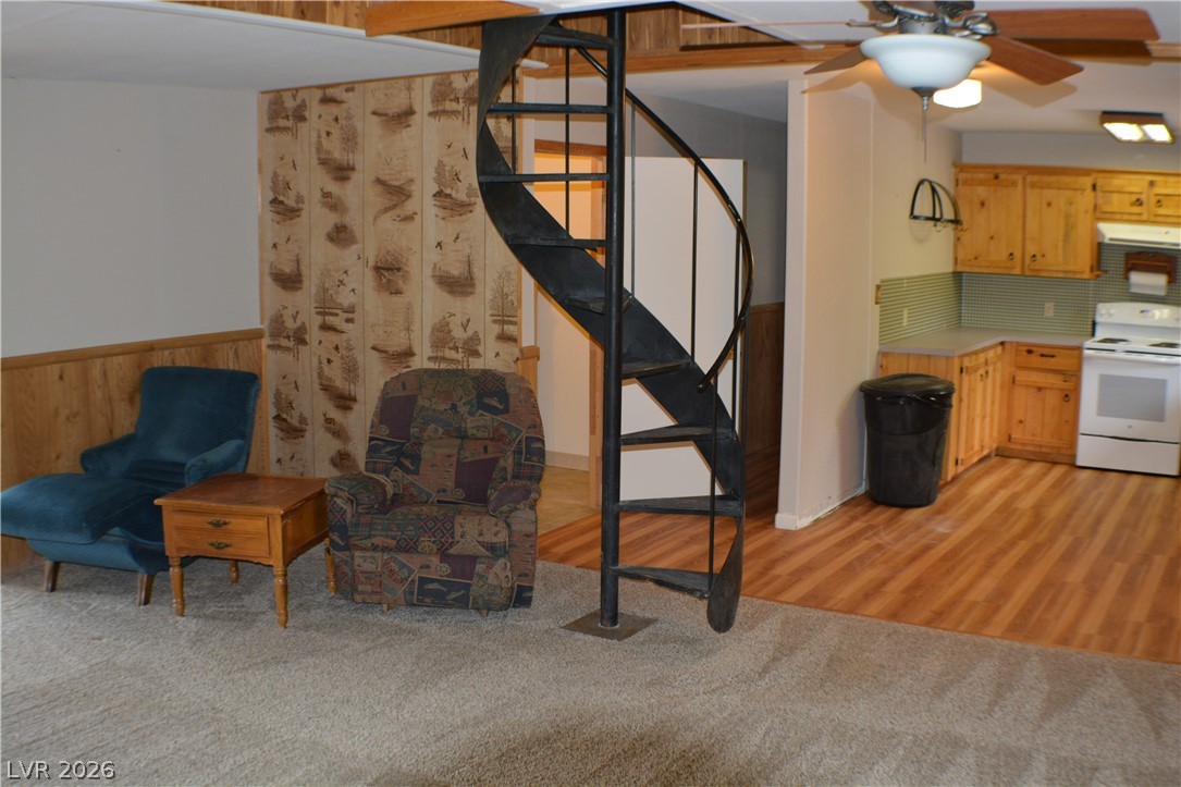 1321 Trout Canyon Road Las Vegas, NV 89124 - Photo 15 of 50 A striking spiral staircase divides this cozy living area from a compact, efficient kitchen.