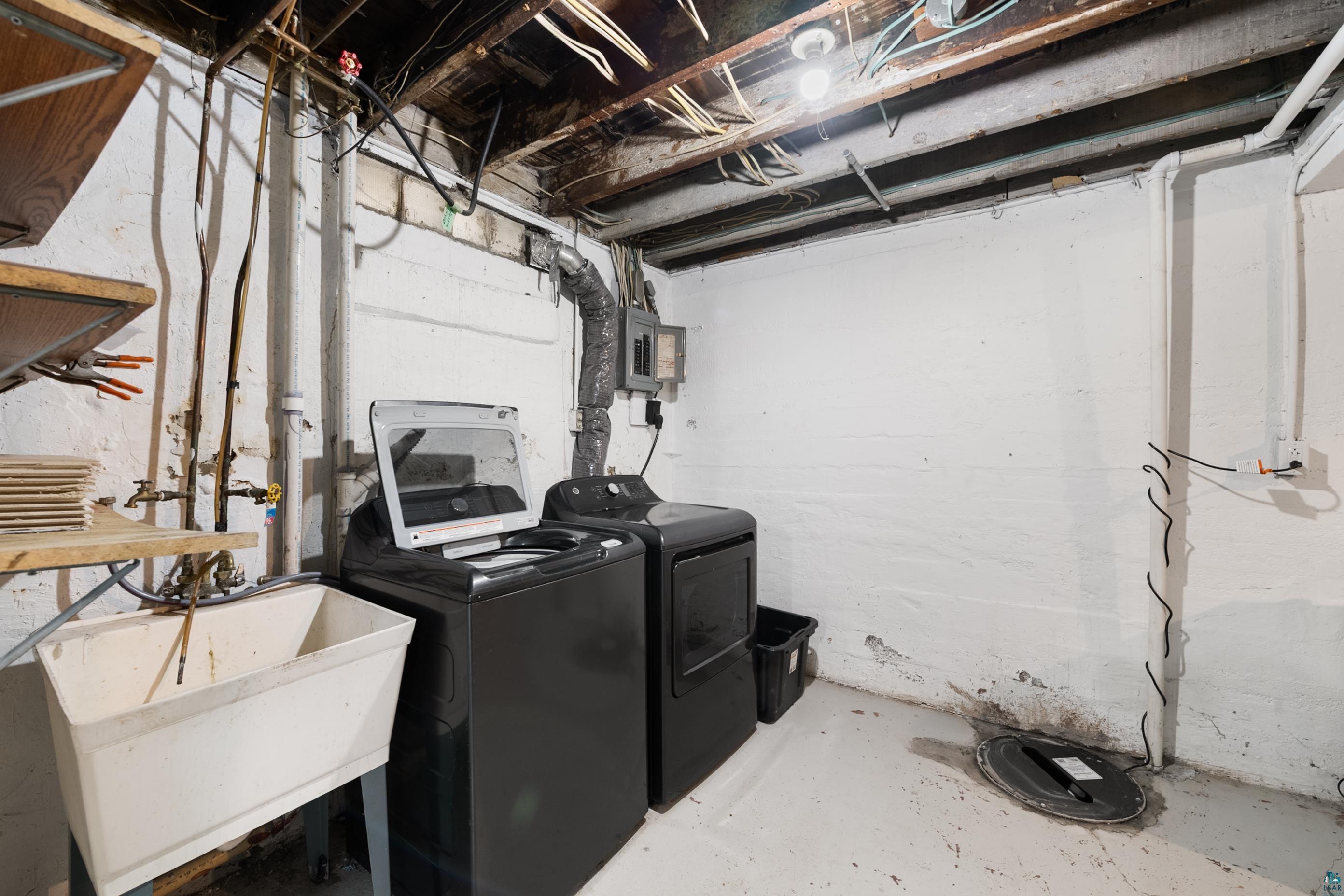 3067 Restormel Street Duluth, MN 55806 - Photo 20 of 25 Basement utility area featuring a utility sink, exposed ceiling joists, and concrete flooring