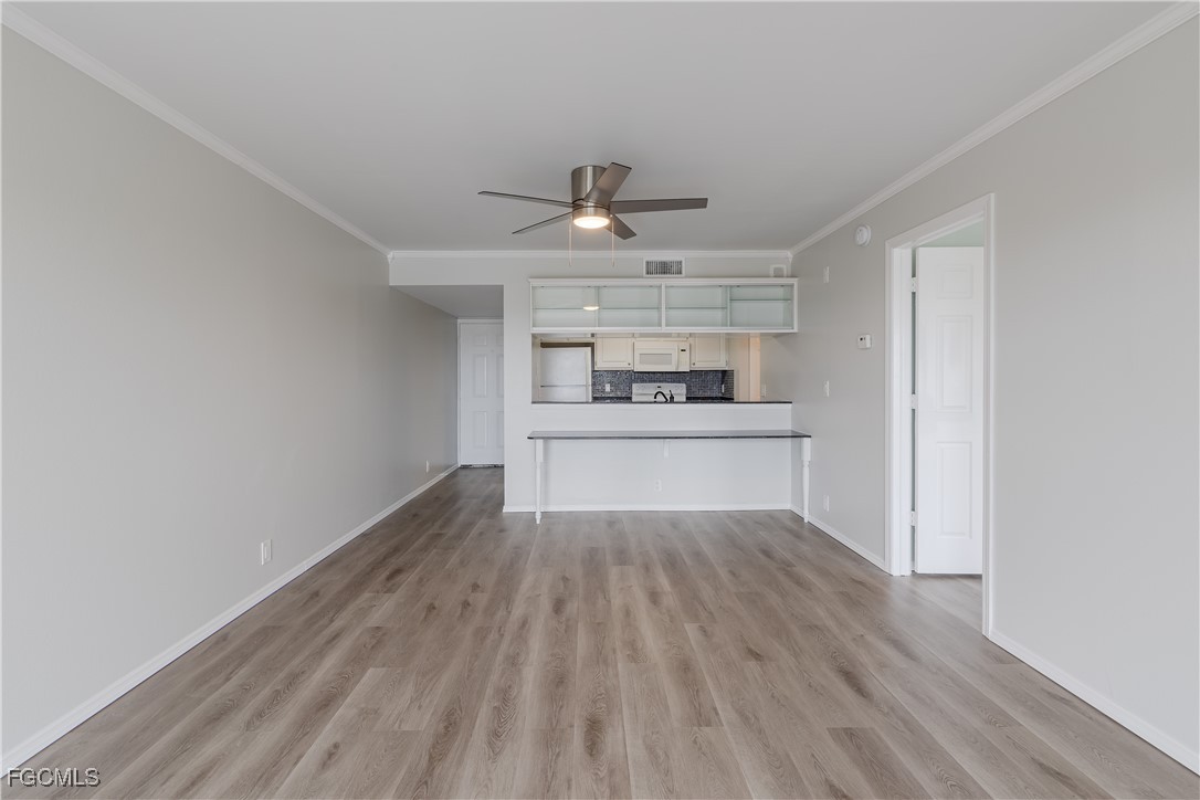 2875 Palm Beach Boulevard, Unit 607 Fort Myers, FL 33916 - Photo 11 of 35 a view of kitchen with wooden floor electronic appliances and window