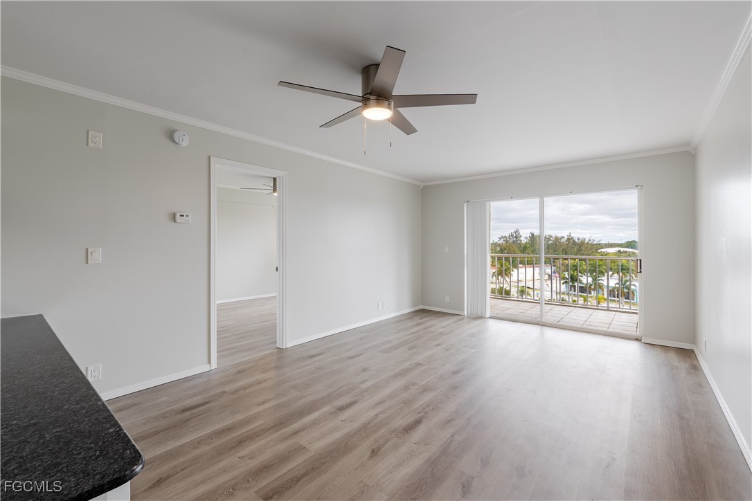 2875 Palm Beach Boulevard, Unit 607 Fort Myers, FL 33916 - Photo 12 of 35 a view of an empty room with wooden floor and a window