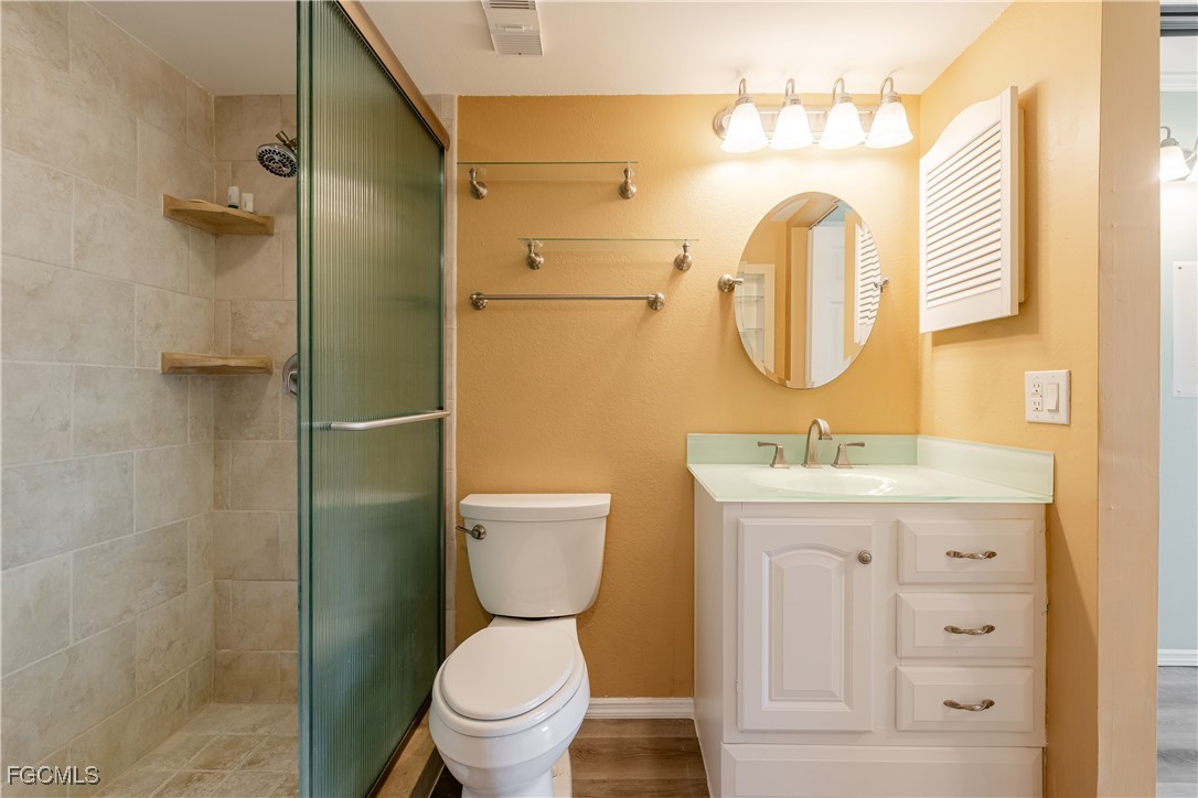 2875 Palm Beach Boulevard, Unit 607 Fort Myers, FL 33916 - Photo 16 of 35 a bathroom with a toilet sink and mirror