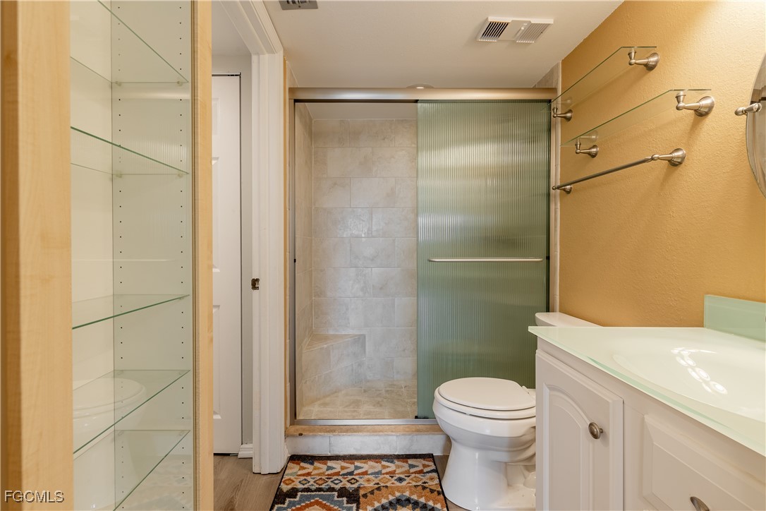 2875 Palm Beach Boulevard, Unit 607 Fort Myers, FL 33916 - Photo 17 of 35 a bathroom with a toilet and a shower