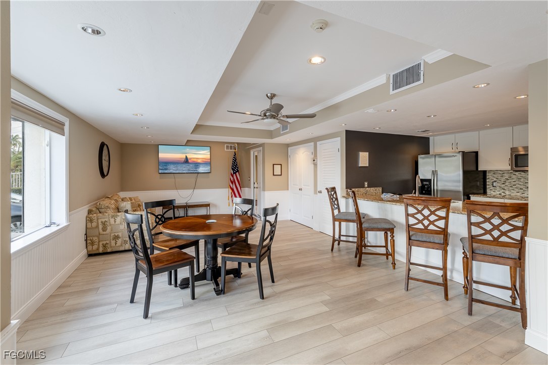 2875 Palm Beach Boulevard, Unit 607 Fort Myers, FL 33916 - Photo 23 of 35 a view of a dining room with furniture and wooden floor