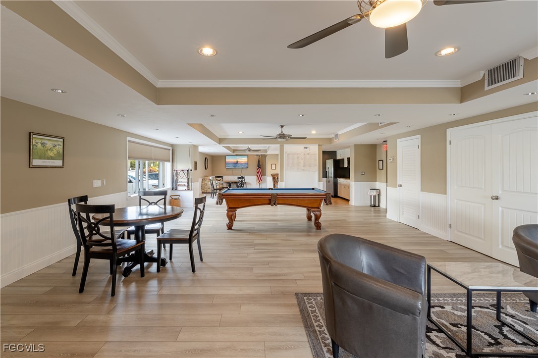 2875 Palm Beach Boulevard, Unit 607 Fort Myers, FL 33916 - Photo 25 of 35 a view of a dining room with furniture and wooden floor