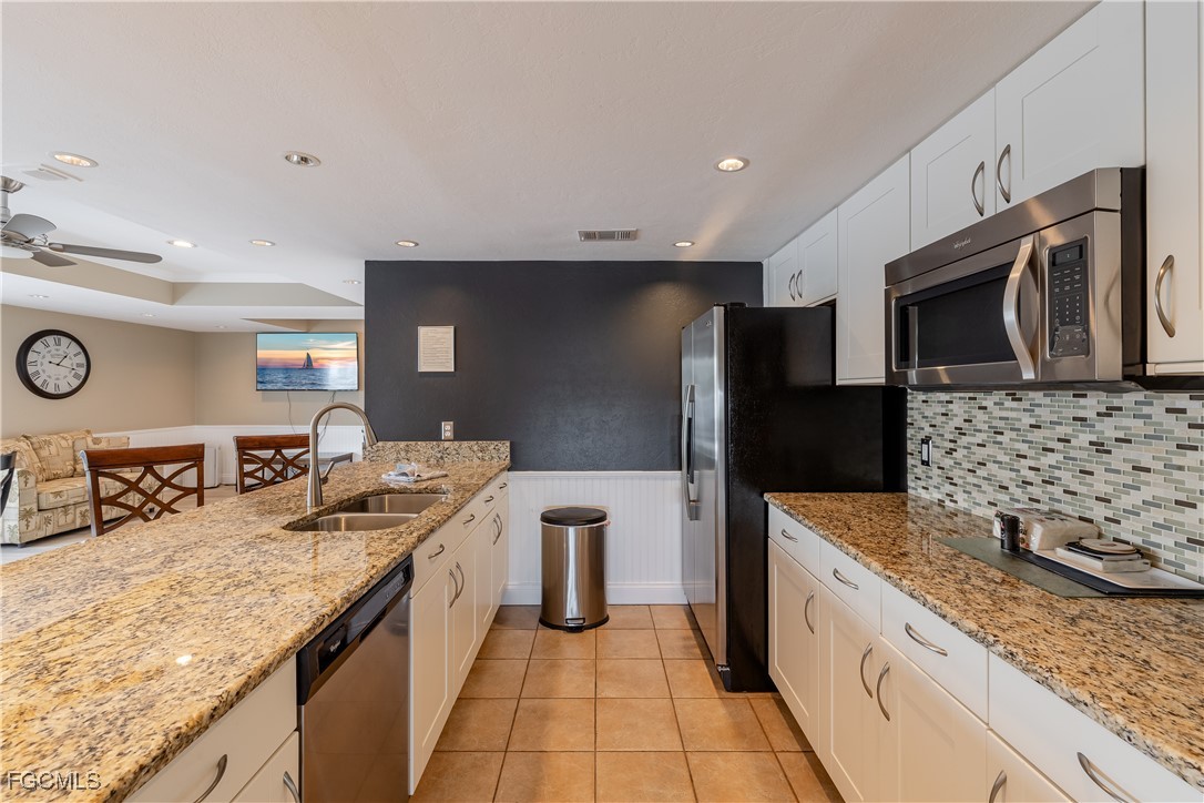 2875 Palm Beach Boulevard, Unit 607 Fort Myers, FL 33916 - Photo 26 of 35 a kitchen with stainless steel appliances granite countertop a sink and stove