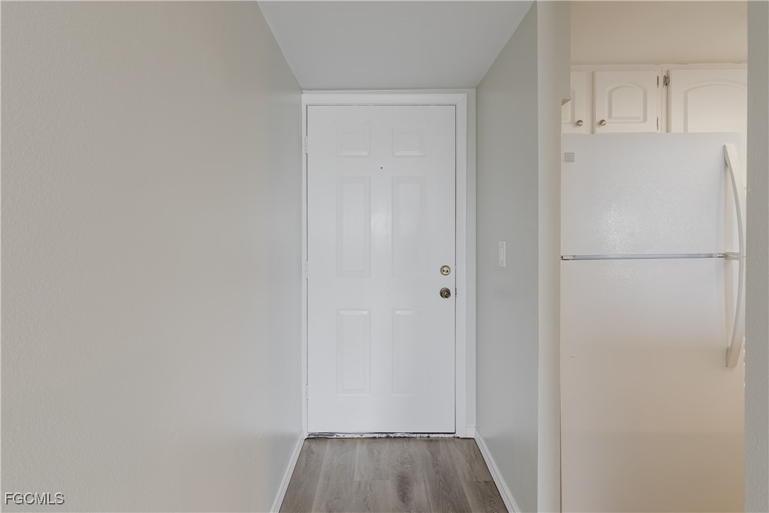 2875 Palm Beach Boulevard, Unit 607 Fort Myers, FL 33916 - Photo 5 of 35 a view of a hallway with wooden floor