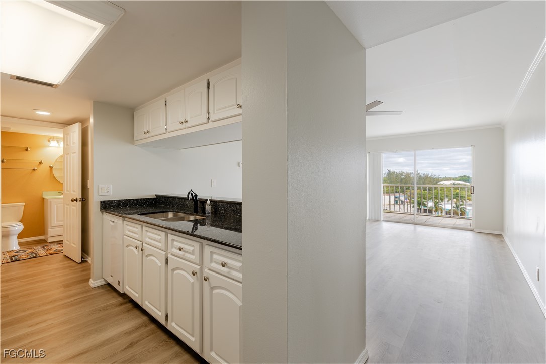 2875 Palm Beach Boulevard, Unit 607 Fort Myers, FL 33916 - Photo 6 of 35 a kitchen with stainless steel appliances granite countertop a stove and a sink
