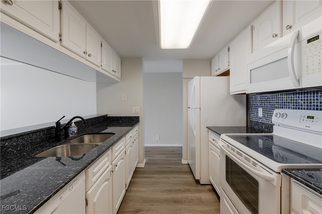 2875 Palm Beach Boulevard, Unit 607 Fort Myers, FL 33916 - Photo 9 of 35 a kitchen that has a sink and a stove