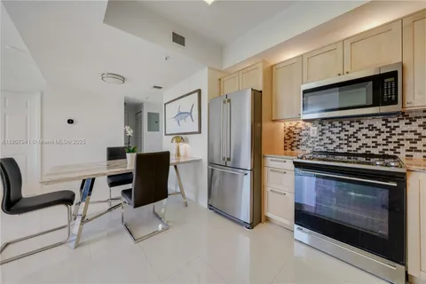 a kitchen with stainless steel appliances a stove a refrigerator and a microwave