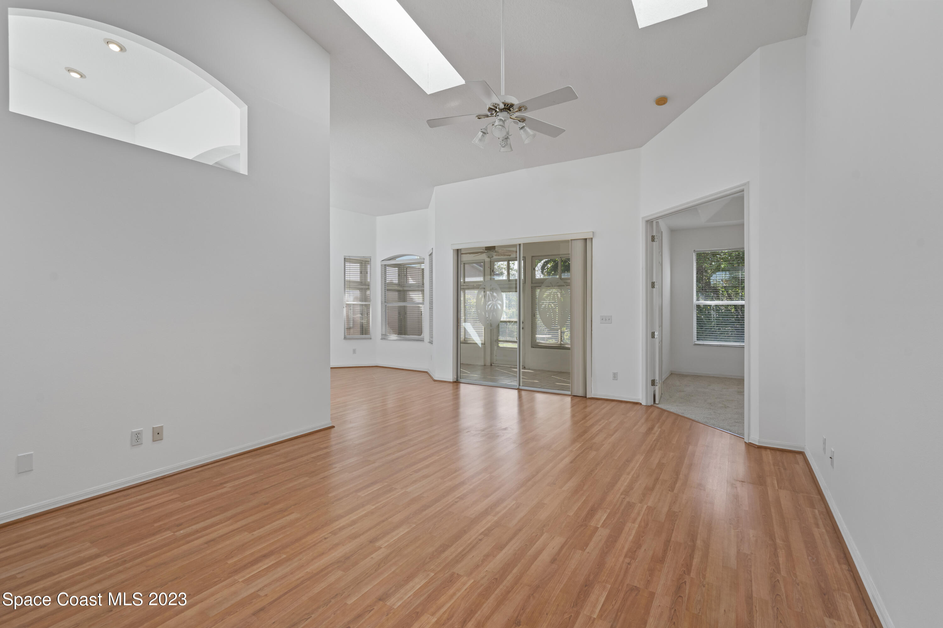 448 Renaissance Avenue Melbourne, FL 32940 - Photo 14 of 57 wooden floor in an empty room with a window