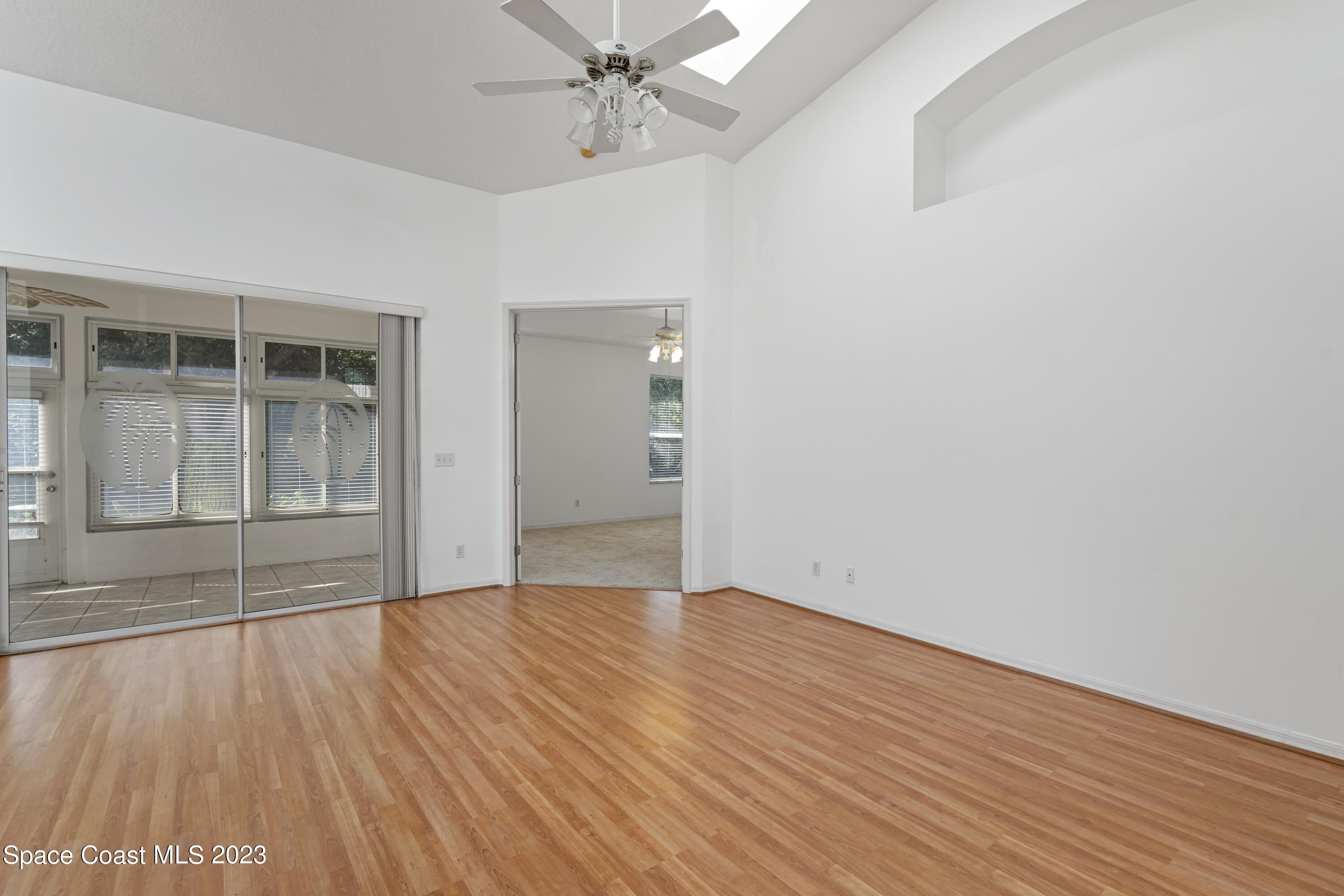 448 Renaissance Avenue Melbourne, FL 32940 - Photo 15 of 57 a view of an empty room with wooden floor and a window