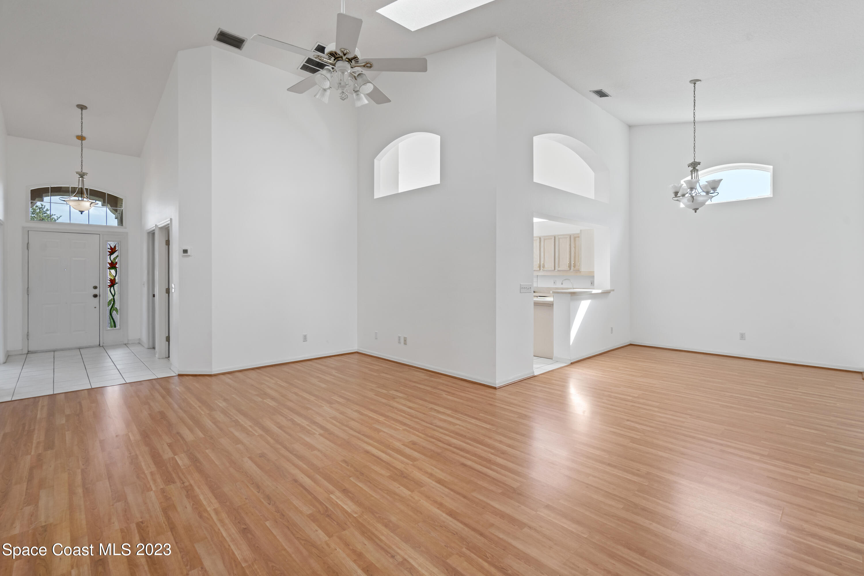 448 Renaissance Avenue Melbourne, FL 32940 - Photo 17 of 57 a view of empty room with wooden floor and ceiling fan