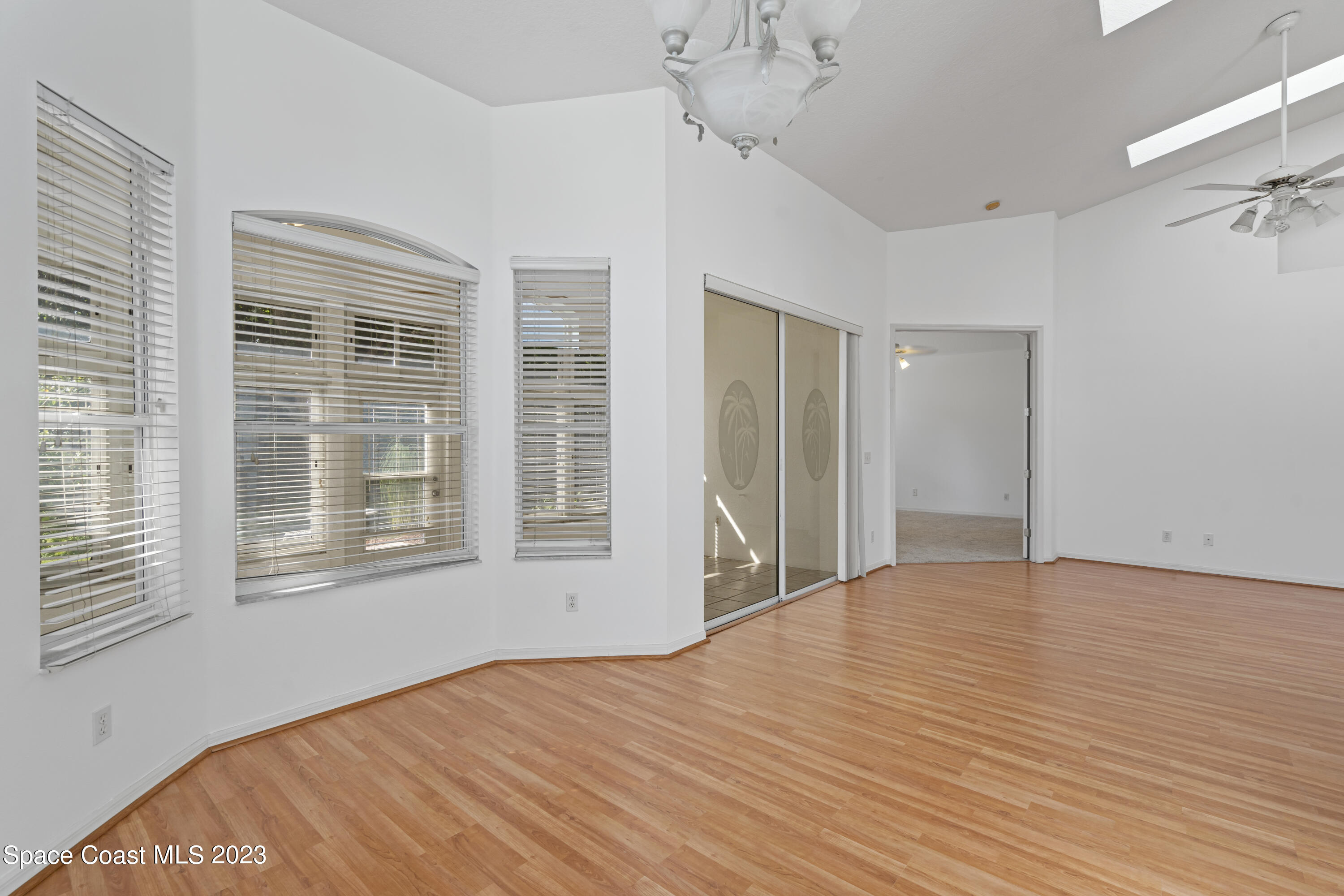 448 Renaissance Avenue Melbourne, FL 32940 - Photo 18 of 57 a view of an empty room with a window and wooden floor