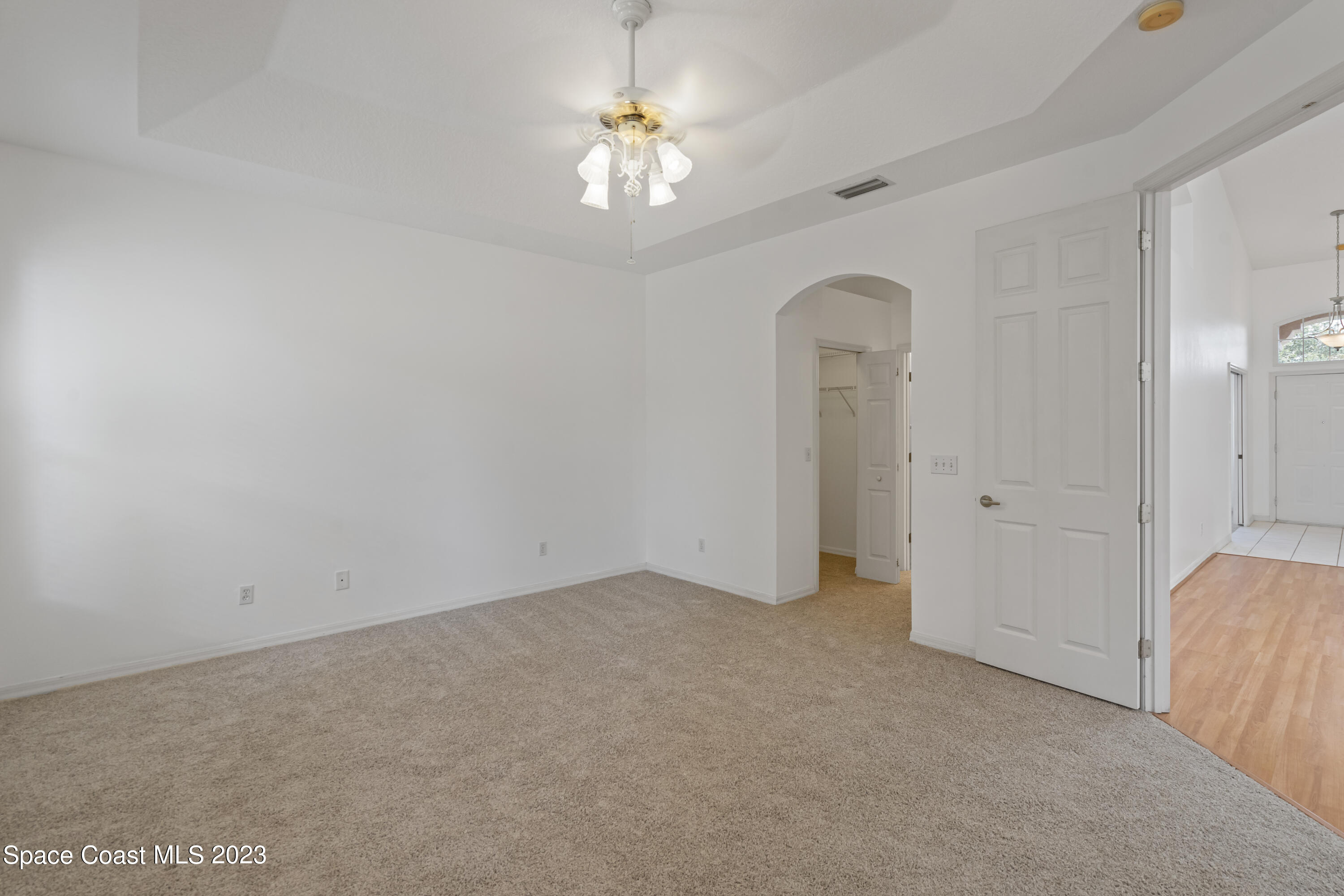 448 Renaissance Avenue Melbourne, FL 32940 - Photo 24 of 57 an empty room with a chandelier fan and a window